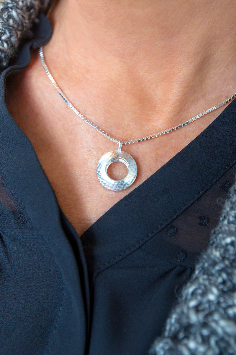 Pareure Model with a 360º Series Small and Short Sterling Silver Pendant Necklace draped around her neck